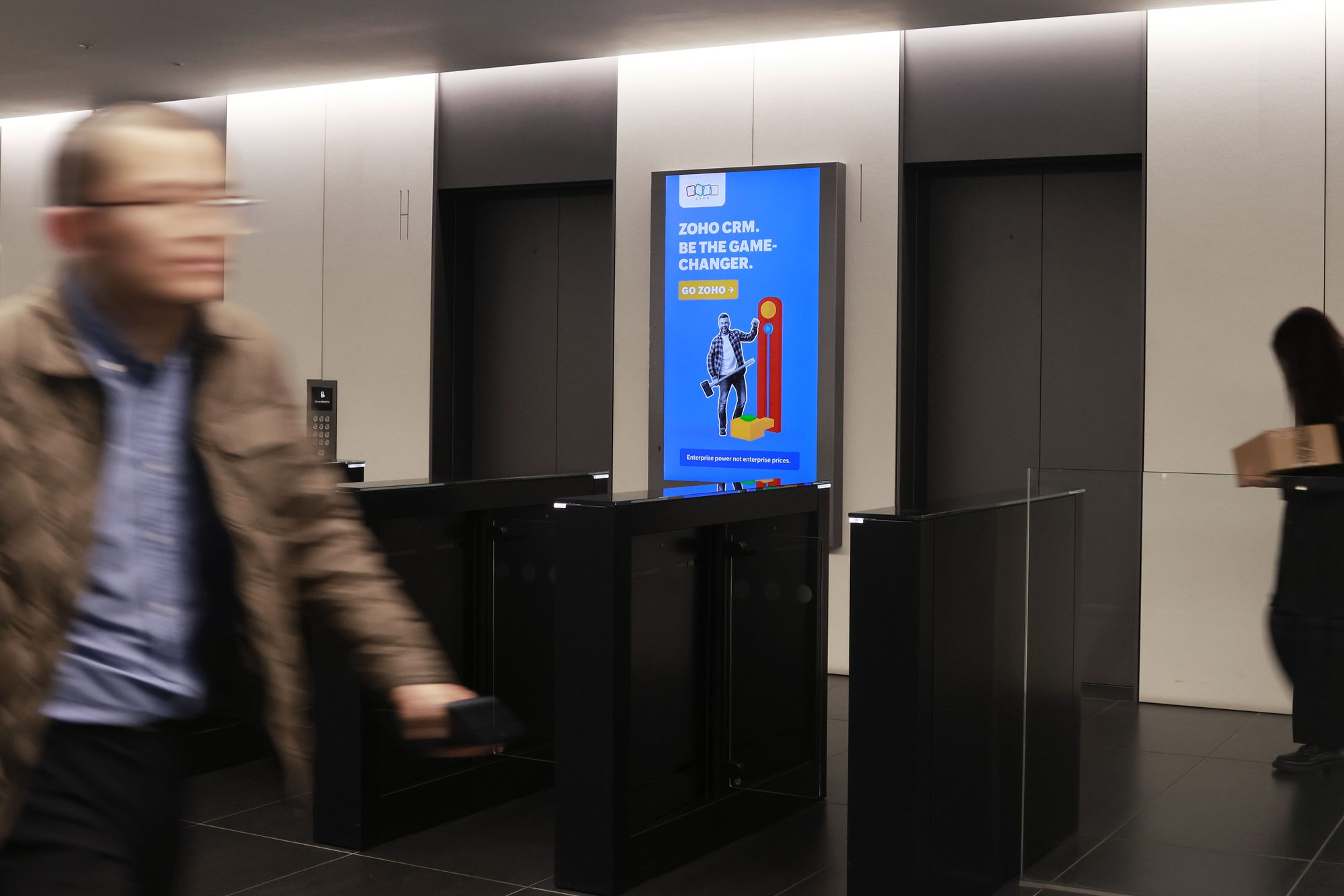 Zoho CRM campaign on ECN screen · premium office DOOH